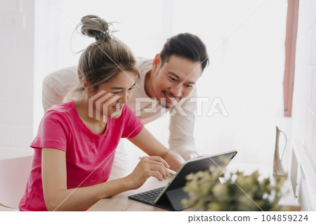 Couple lover teaching each other to solve problem and work online. Couple lover teaching each other to solve problem and work online. 104859224