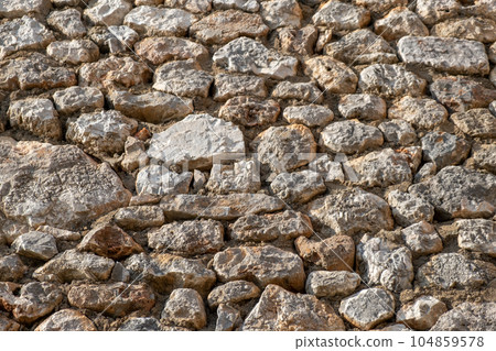 Texture of a stone wall. Old castle stone wall texture background. Stone wall as a background or texture. Part of a stone wall, for background or texture 104859578