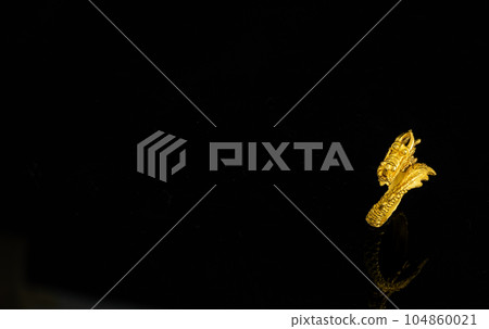 isolated golden dragon ring on black background isolated golden dragon ring on black background 104860021