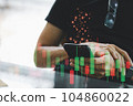closeup man using smart phone with candle stick graph and dollar sign 104860022