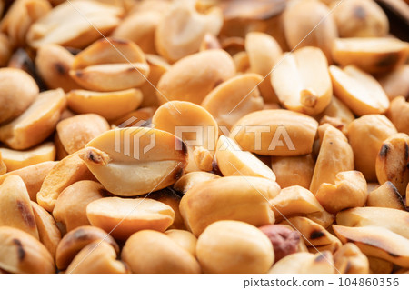 Pile of roasted peeled peanuts 104860356