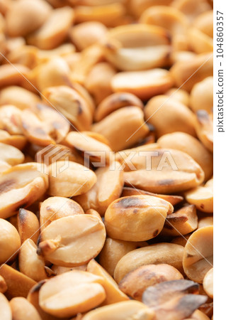 Pile of roasted peeled peanuts. 104860357