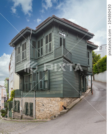 Facade of colorful wooden house painted in green, located in Kuzguncuk, Uskudar district, Istanbul, Turkey 104860430