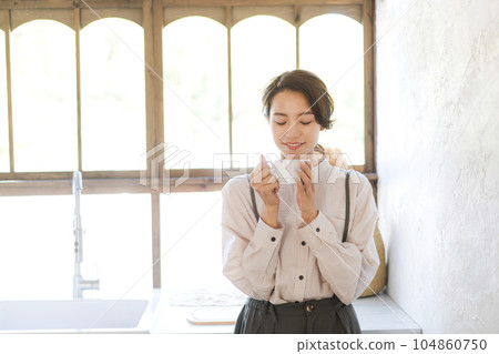 A woman drinking coffee A woman drinking coffee 104860750