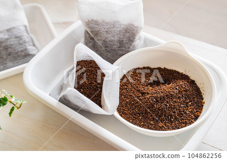 Dried coffee grounds in a tea bag Dried coffee grounds in a tea bag 104862256
