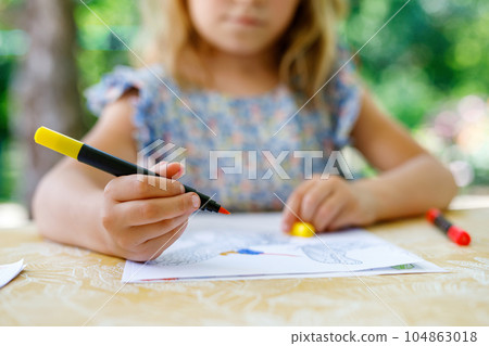 Cute Little Preschooler Child Drawing at Home. Happy Girl with Colorful Felt Pens. Hobby for Children. Leisure Activity for Small Kids. 104863018