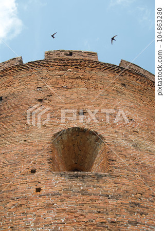 Fragments of the old fortress. From red brick. Fortress loopholes. Fragments of the old fortress. From red brick. Fortress loopholes. 104863280