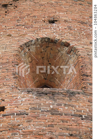 Fragments of the old fortress. From red brick. Fortress loopholes. Fragments of the old fortress. From red brick. Fortress loopholes. 104863284