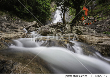 Beautiful natural Sarika waterfall with rocks in the foreground at Khao Yai National Park, Nakhon Nayok, Thailand Beautiful natural Sarika waterfall with rocks in the foreground at Khao Yai National Park, Nakhon Nayok, Thailand 104865137