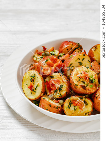 Herbs Garlic Potatoes in white bowl, top view Herbs Garlic Potatoes in white bowl, top view 104865334