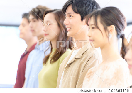 Young men and women lining up and listening Young men and women lining up and listening 104865556