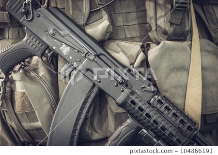 Military equipment of a soldier, machine gun on the background of body armor Military equipment of a soldier, machine gun on the background of body armor 104866191