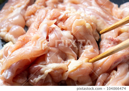A cooking scene where chicken (young chicken seseri) is fried in a frying pan. A cooking scene where chicken (young chicken seseri) is fried in a frying pan. 104866474
