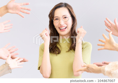 Young woman receiving praise and smiling Young woman receiving praise and smiling 104867007