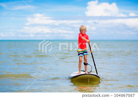 Child on stand up paddle. Water and beach sport 104867087