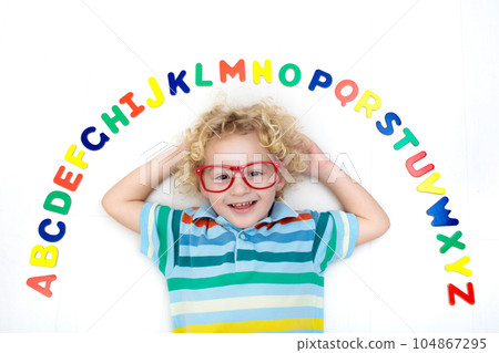 Child learning letters of alphabet and reading 104867295