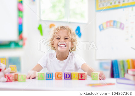 Child learning letters. Kid with wooden abc blocks Child learning letters. Kid with wooden abc blocks 104867308