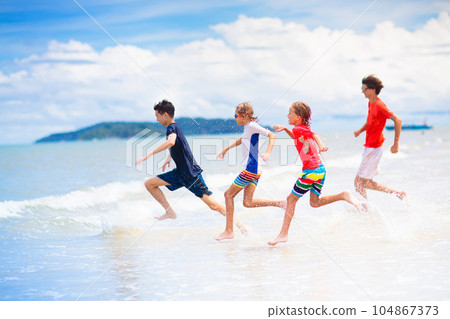 Kids play on tropical beach. Sand and water toy. 104867373