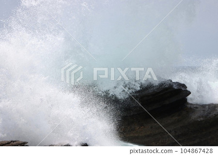 waves crashing against rocks waves crashing against rocks 104867428