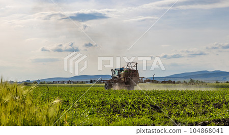Tractor spraying pesticide and insecticide Tractor spraying pesticide and insecticide 104868041