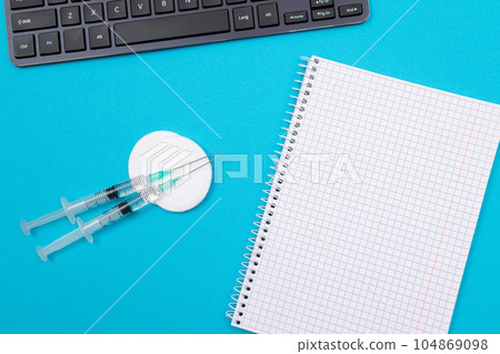 Vaccination or Revaccination Concept - Three Insulin Syringe on Blue Table 104869098