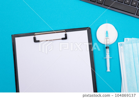 Vaccination or Revaccination Concept - A Medical Syringe on Blue Table Vaccination or Revaccination Concept - A Medical Syringe on Blue Table 104869137