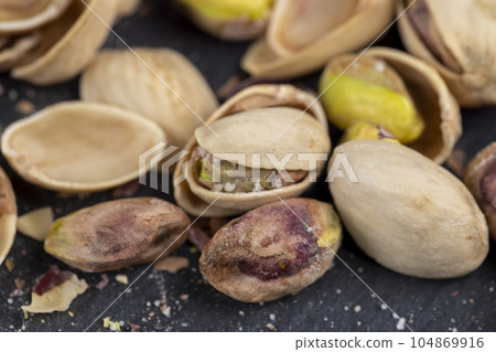 a large number of salty and crispy pistachios close-up 104869916