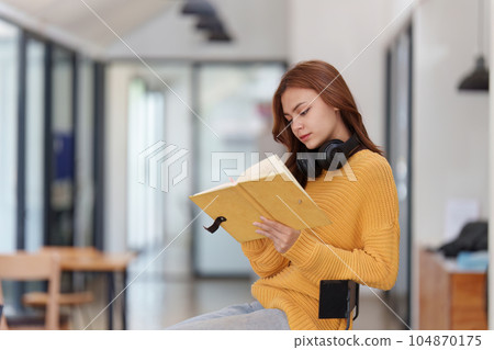Beautiful young Asian woman college student at classroom. College student working on the college campus. back to school concept Beautiful young Asian woman college student at classroom. College student working on the college campus. back to school concept 104870175