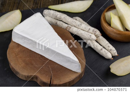 delicious sliced cheese with edible white mold delicious sliced cheese with edible white mold 104870371