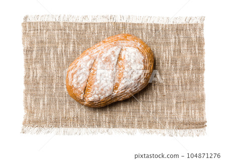 Freshly baked delicious french bread with napkin isolated on white background top view. Healthy white bread loaf Freshly baked delicious french bread with napkin isolated on white background top view. Healthy white bread loaf 104871276