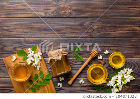 honey jar with acacia flowers and leaves. fresh honey top view flat lay 104871328