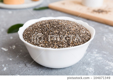 Chia seeds in bowl on colored background. Healthy Salvia hispanica in small bowl. Healthy superfood 104871349