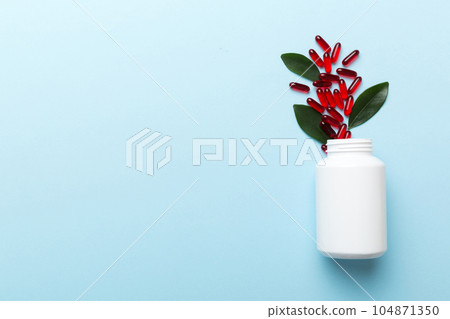 different drugs and health supplement pills poured from a medicine bottle health care and medical top view on colored background different drugs and health supplement pills poured from a medicine bottle health care and medical top view on colored background 104871350