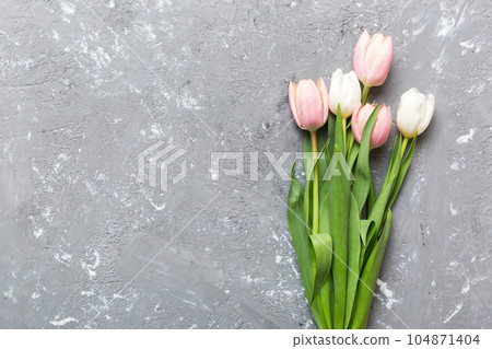 Bouquet of pink tulips on colored table background . Top view with copy space. Waiting for spring. Happy Easter card. Flat lay 104871404