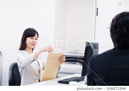 Female employee doing clerical work in the office Female employee doing clerical work in the office 104871846