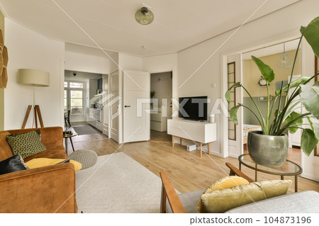 a living room with couches, chairs and a flat screen tv on the wall in the middle of the room a living room with couches, chairs and a flat screen tv on the wall in the middle of the room 104873196