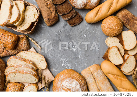 Homemade natural breads. Different kinds of fresh bread as background, top view with copy space Homemade natural breads. Different kinds of fresh bread as background, top view with copy space 104873293