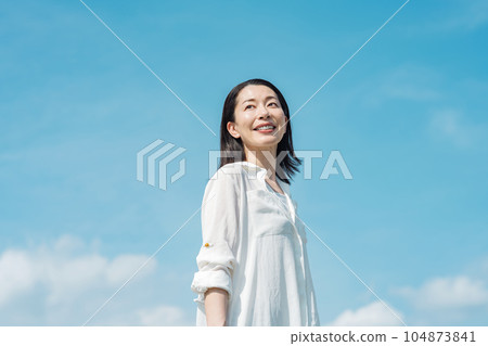 Blue sky portrait of a middle-aged woman 104873841