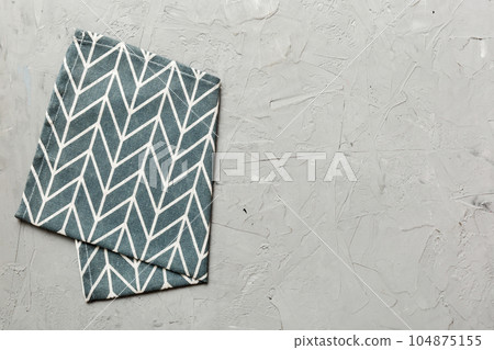 top view with blue kitchen napkin isolated on table background. Folded cloth for mockup with copy space, Flat lay. Minimal style top view with blue kitchen napkin isolated on table background. Folded cloth for mockup with copy space, Flat lay. Minimal style 104875155