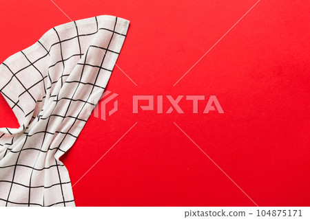 top view with white empty kitchen napkin isolated on table background. Folded cloth for mockup with copy space, Flat lay. Minimal style 104875171
