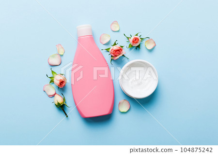 Fancy healthcare bottles for cream with rose flower. Natural oranic spa cosmetics concept. Mockup, template, Top view Fancy healthcare bottles for cream with rose flower. Natural oranic spa cosmetics concept. Mockup, template, Top view 104875242