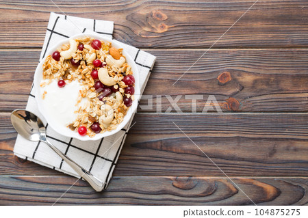 Healthy breakfast food with granola, yogurt, fruits and nuts. Dessert parfait with dried fruits for breakfast Healthy breakfast food with granola, yogurt, fruits and nuts. Dessert parfait with dried fruits for breakfast 104875275