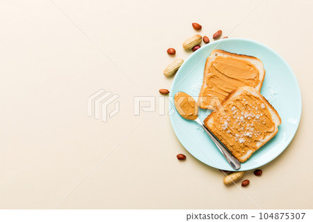 Peanut butter sandwiches or toasts on light table background.Breakfast. Vegetarian food. American cuisine top view vith copy space Peanut butter sandwiches or toasts on light table background.Breakfast. Vegetarian food. American cuisine top view vith copy space 104875307