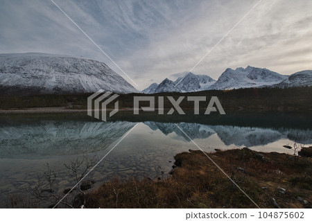 Panorama view and reflection of the Lake Aspevatnet in Svensby, Norway. 104875602