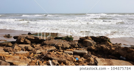 old rocks in front of sea waves and sky old rocks in front of sea waves and sky 104875784