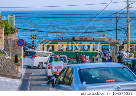 Kamakura cityscape in Japan Pilgrimage boom again, Enoshima Electric Railway / Kamakura High School Mae No. 1 railroad crossing crowded with tourists visiting Japan 104875821