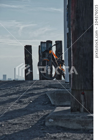Vertical shot of an Orange and black mountain bike on top of the Haniel slagheap in the Ruhr area 104876035