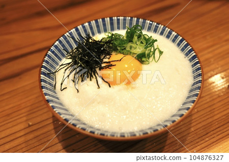 Grated yam rice topped with raw egg Grated yam rice topped with raw egg 104876327