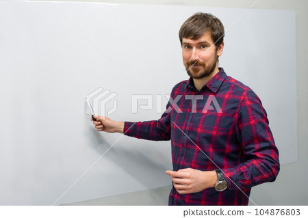 A young man conducts online training in the office. A young man conducts online training in the office. 104876803