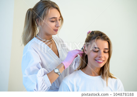 Specialist doing plasmolifting of scalp, stages of baldness, improving condition of hair. Specialist doing plasmolifting of scalp, stages of baldness, improving condition of hair. 104878188